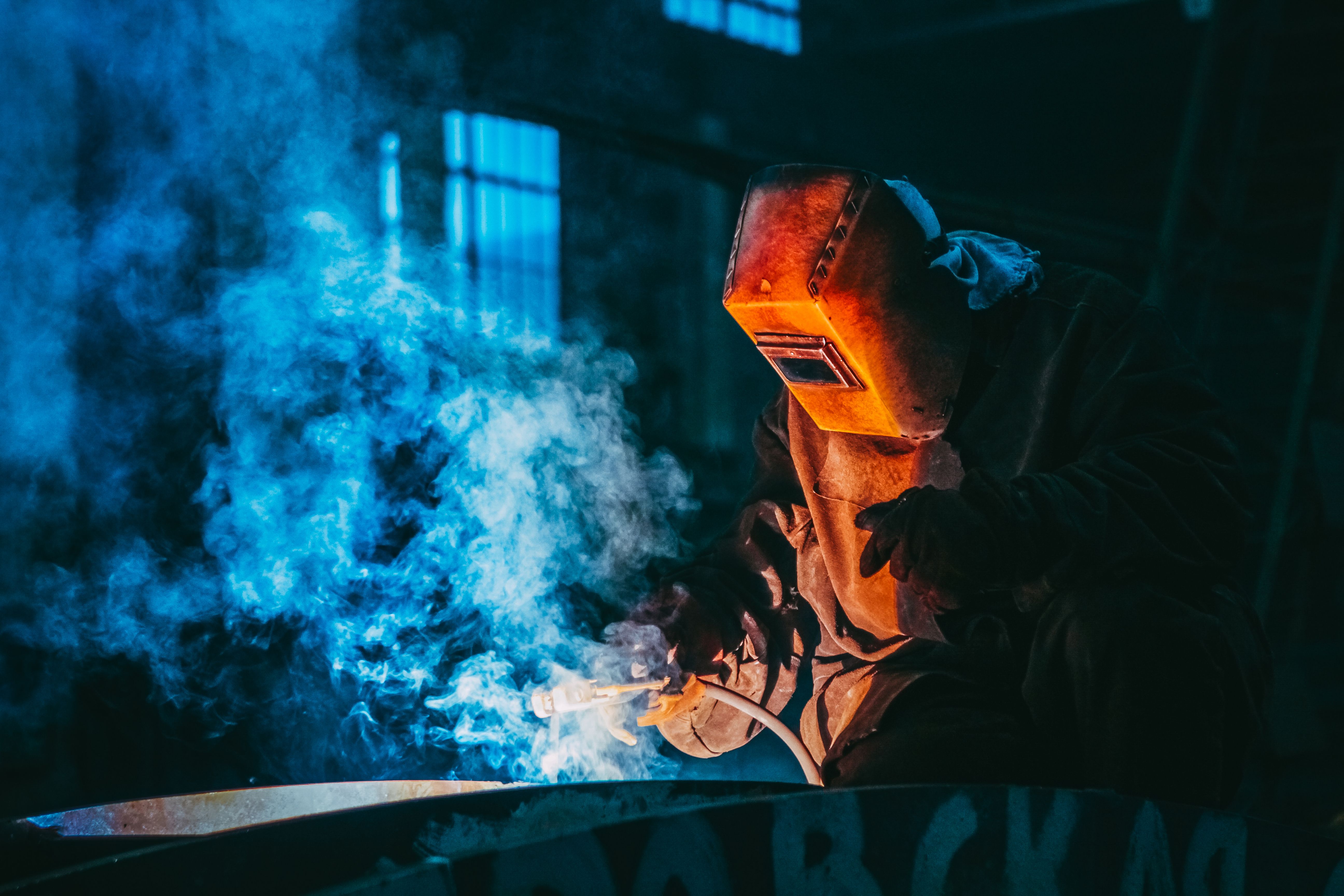 Welder working on metal fabrication project